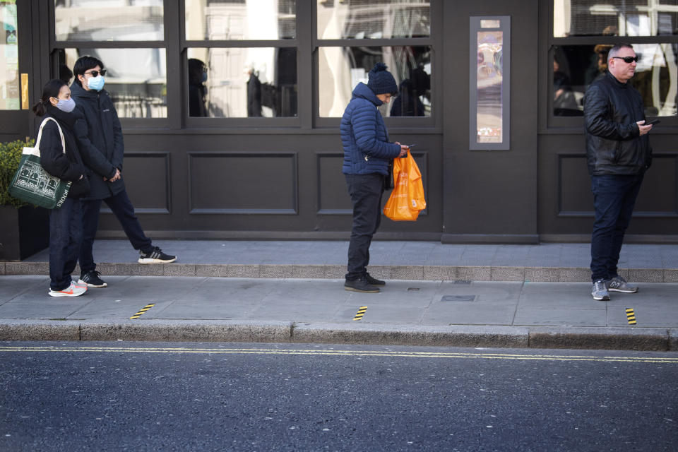 Customers queue between social distancing markers on the pavement outside a supermarket in Westminster, London after Prime Minister Boris Johnson put the UK in lockdown to help curb the spread of the coronavirus.