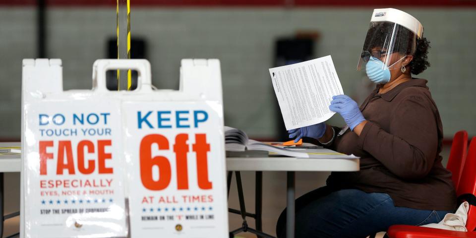 Louisa Boyer, a provisional election judge, reviews paperwork at a voting center in Baltimore, MD