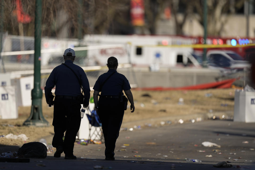 EMTs walk around the scene of the shootings that followed the Kansas City Chiefs victory parade.