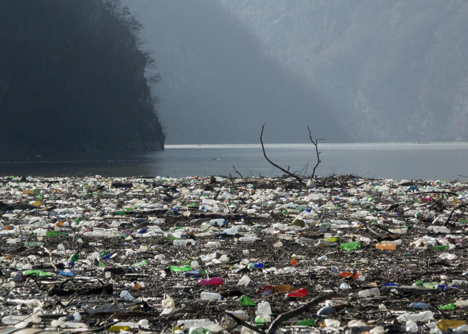 Plastic bottles, wooden planks, rusty barrels and other garbage clogging the Drina river near the eastern Bosnian town of Visegrad, Bosnia, Tuesday, Jan. 5, 2021. Further upstream, the Drina tributaries in Montenegro, Serbia and Bosnia are carrying even more waste after the swollen rivers surged over the the landfills by their banks. The Balkan nations have poor waste management and tons of garbage routinely end up in rivers. (AP Photo/Eldar Emric)