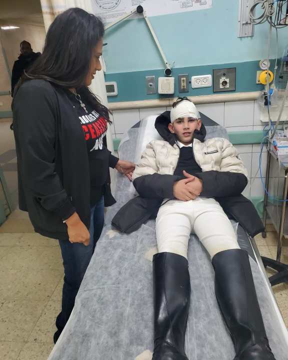 <em>Cortez meets with a young Palestinian boy in an Israeli hospital</em>