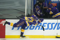 Los Angeles Kings right wing Dustin Brown (23) catches himself on the boards as his stick flies and players shield themselves during the second period of an NHL hockey game against the Anaheim Ducks Tuesday, Feb. 2, 2021, in Los Angeles. (AP Photo/Ashley Landis)