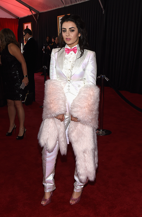 Known for her outrageous fashion, Charli XCX didn't disappoint at the 2015 Grammy Awards, wearing a white satin trouser suit, with a fur shawl draped over her arms.