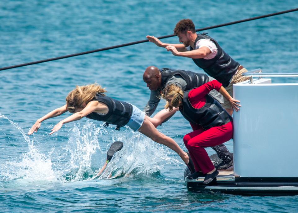 Diving in: Coyle, Garraway, Wright, Haskell and Stephenson are seen launching themselves into the waters (SplashNews.com)