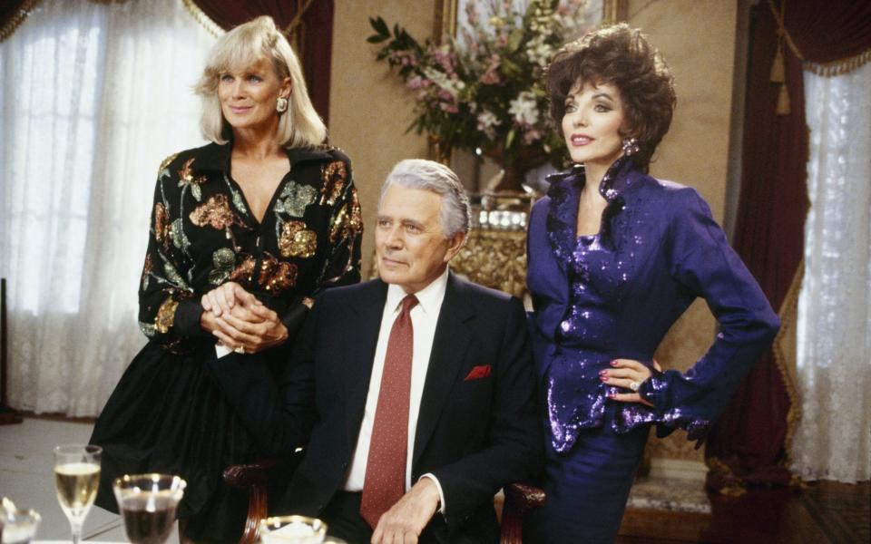 Collins with Dynasty co-stars John Forsythe and Linda Evans - Getty