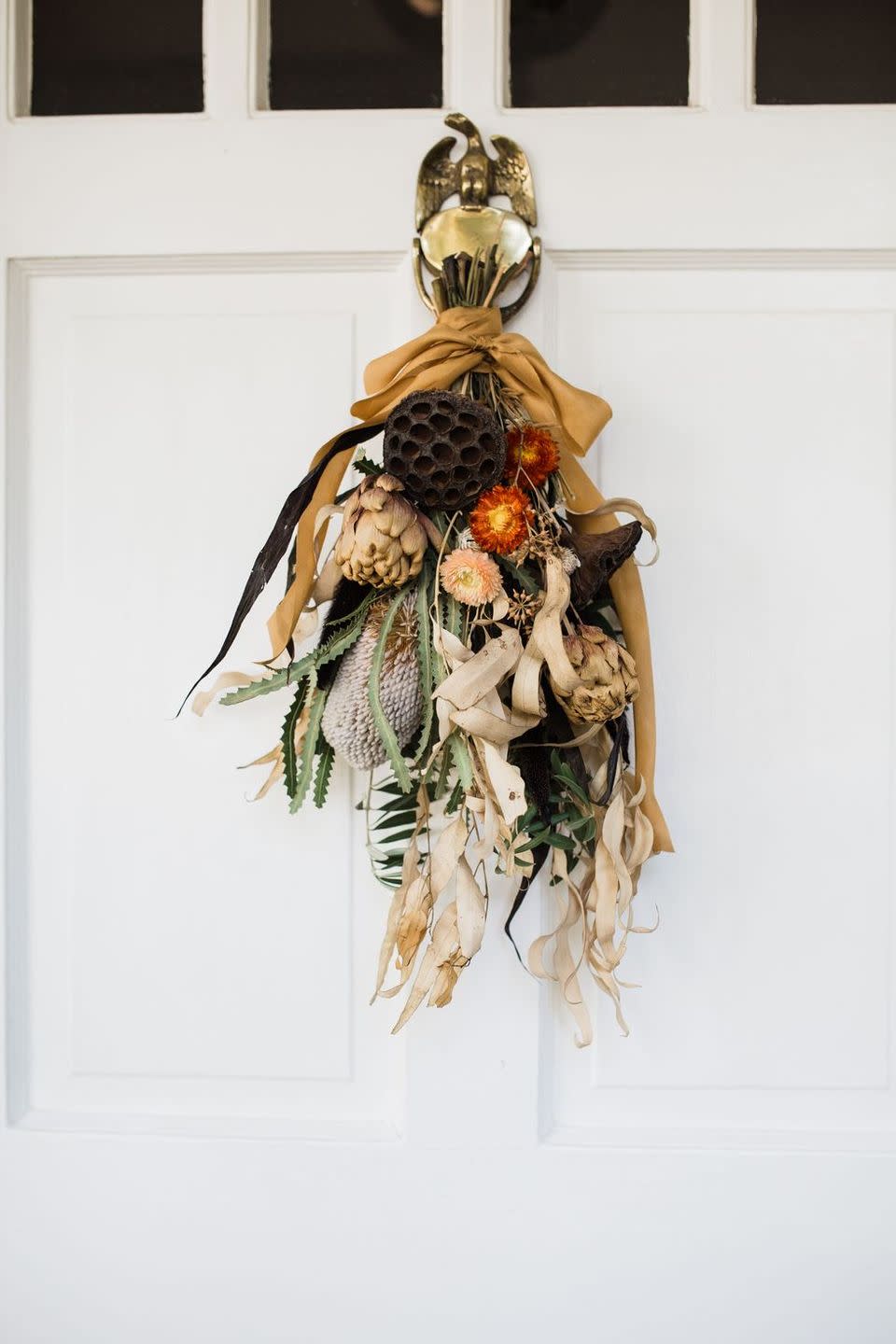 <p>Wreaths are great, but door hangings are even better for someone looking to switch it up a bit and who wants a DIY project. Using dried florals means you can leave it up all season long, too. Learn how to make your own from <a href="https://cheetahisthenewblack.com/living/lifestyle/diy-seasonal-door-swag/" rel="nofollow noopener" target="_blank" data-ylk="slk:Cheetah Is the New Black;elm:context_link;itc:0;sec:content-canvas" class="link ">Cheetah Is the New Black</a>.</p>