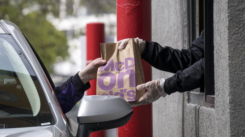 McDonald's drive-thru customer accepts bag