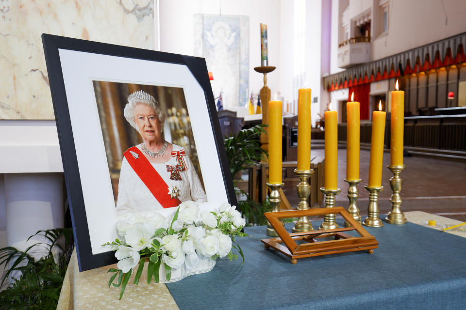 WELLINGTON, NEW ZEALAND - SEPTEMBER 26: A photo of Queen Elizabeth II sits on The Table of Remembrance during a State Memorial Service for Queen Elizabeth II at the Wellington Cathedral of St Paul on September 26, 2022 in Wellington, New Zealand. New Zealand is commemorating Queen Elizabeth II with a state memorial service and one-off public holiday on Monday, called Queen Elizabeth Memorial Day. Queen Elizabeth II died at Balmoral Castle in Scotland aged 96 on September 8, 2022, with her funeral held at Westminster Abbey on September 19, 2022. Elizabeth Alexandra Mary Windsor was born in Bruton Street, Mayfair, London on 21 April 1926. She married Prince Philip in 1947 and acceded the throne of the United Kingdom and Commonwealth on 6 February 1952 after the death of her Father, King George VI. Queen Elizabeth II was the United Kingdom's longest-serving monarch. (Photo by Hagen Hopkins/Getty Images)