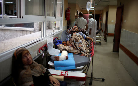 An injured Palestinian lies on a bed in the corridor of a hospital in Gaza City May 15, 2018. REUTERS/Mohammed Salem