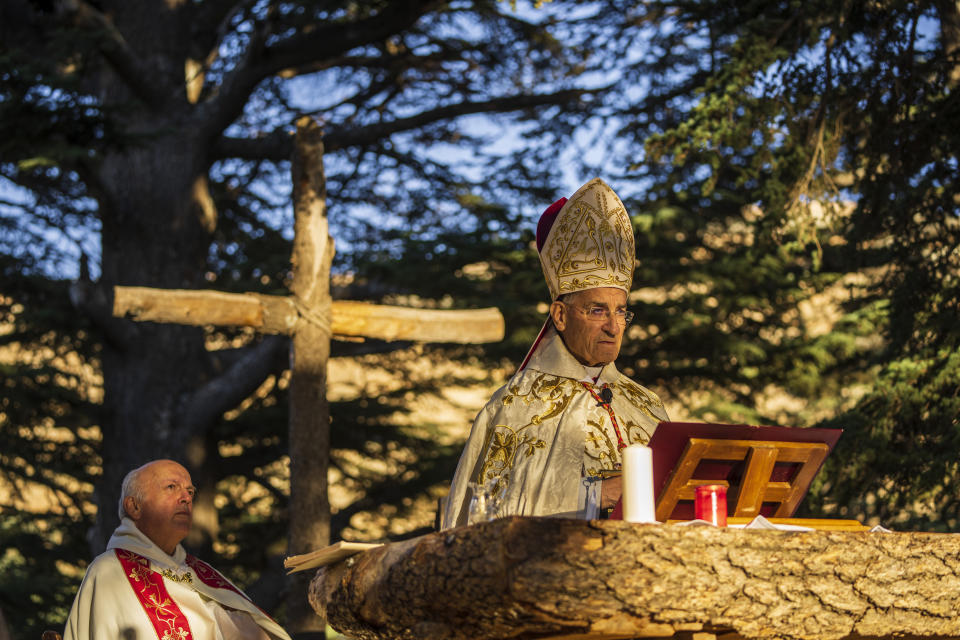 Lebanese Maronite Christian Patriarch Beshara al-Rai, right, speaks during a sermon to commemorate the Feast of the Transfiguration in the Cedars of God forest, in the northeast mountain town of Bcharre, Lebanon, Saturday, Aug. 5, 2023. For Lebanon's Christians, the cedars are sacred, these tough evergreen trees that survive the mountain's harsh snowy winters. They point out with pride that Lebanon's cedars are mentioned 103 times in the Bible. (AP Photo/Hassan Ammar)
