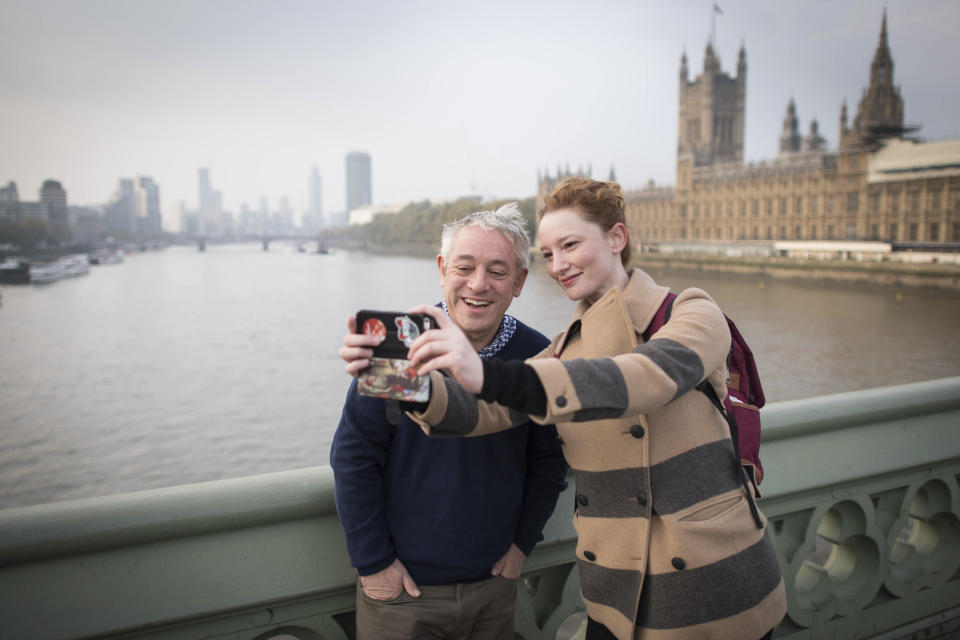 A woman takes a selfie with Speaker of the House of Commons, John Bercow, on Westminster Bridge in London Thursday Oct. 31, 2019. The speaker of Britain’s House of Commons has become a global celebrity for his loud ties, even louder voice and star turn at the center of Britain’s Brexit drama. On Thursday Oct. 31, 2019, he is stepping down after 10 years in the job. (Stefan Rousseau/PA via AP)