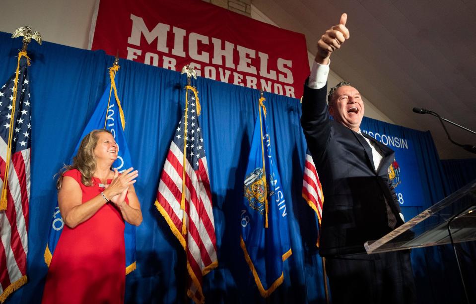 Tim Michels claims victory in the Republican primary for governor Tuesday, Aug. 9, 2022, at Tuscan Hall Venue and Catering in Waukesha. He will face Gov. Tony Evers, a Democrat, in the general election. At left, is his wife, Barbara Michels.