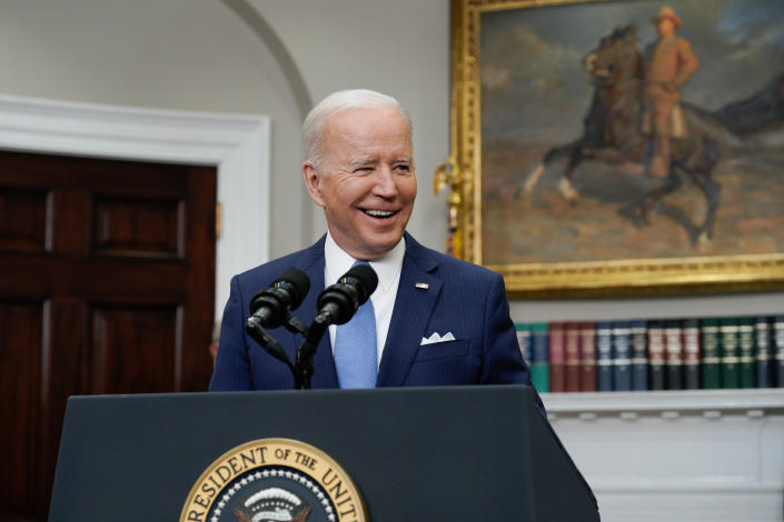 President Biden stands at a lectern in the White House.