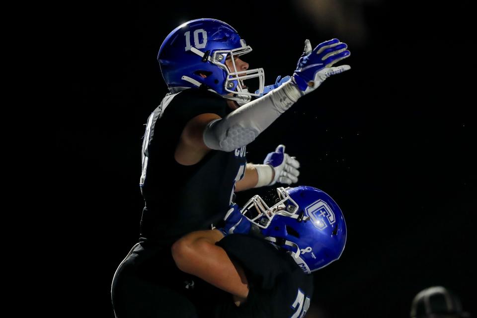 Covington Catholic tight end Willie Rodriguez (10) reacts after scoring a touchdown with offensive lineman Quentin Jones (76) in the second half against Johnson Central at Covington Catholic High School Nov. 17, 2023.