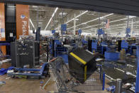 Items litter the ground Wednesday, Oct. 28, 2020, inside a Walmart in Philadelphia that was damaged in last night's protests. Demonstrators protested the death of Walter Wallace Jr., who was fatally shot by police Monday after authorities say he ignored orders to drop a knife. Some businesses were cleaning up damage after video showed people streaming into stores and stealing goods on the opposite side of the city from where Wallace was shot. (AP Photo/Michael Perez)