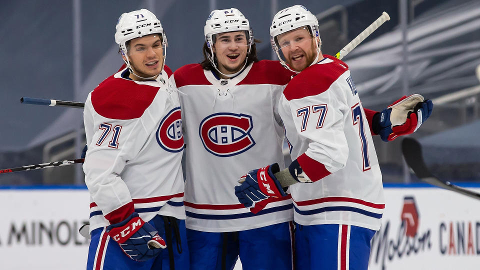 Canadiens rookie Alexander Romanov celebrates with teammates Jake Evans (left) and Brett Kulak (right) after scoring his first NHL goal against the Edmonton Oilers. (Photo by Codie McLachlan/Getty Images)