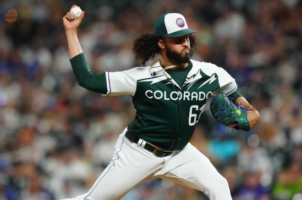 Jun 28, 2023; Denver, Colorado, USA; Colorado Rockies relief pitcher Justin Lawrence (61) delivers a pitch in the ninth inning against the Los Angeles Dodgers at Coors Field. Mandatory Credit: Ron Chenoy/USA TODAY Sports