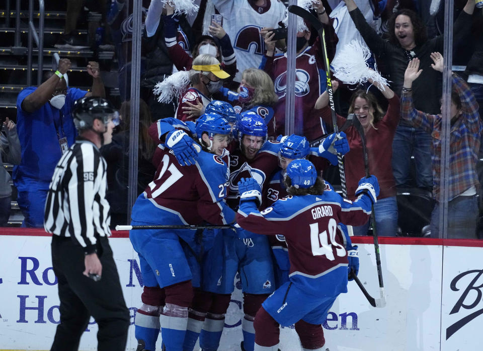 Colorado Avalanche left wing Brandon Saad (20) is congratulated by teammates after his goal against the Vegas Golden Knights during the first period in Game 2 of an NHL hockey Stanley Cup second-round playoff series Wednesday, June 2, 2021, in Denver. (AP Photo/Jack Dempsey)