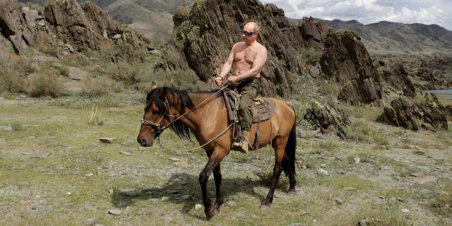Vladimir Putin shirtless on a horse.