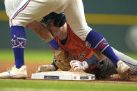 Houston Astros' Alex Bregman, right, slides safely into third base after hitting a two-run triple as Texas Rangers third baseman Josh Jung tags him during the first inning in Game 4 of the baseball American League Championship Series Thursday, Oct. 19, 2023, in Arlington, Texas. (AP Photo/Julio Cortez)