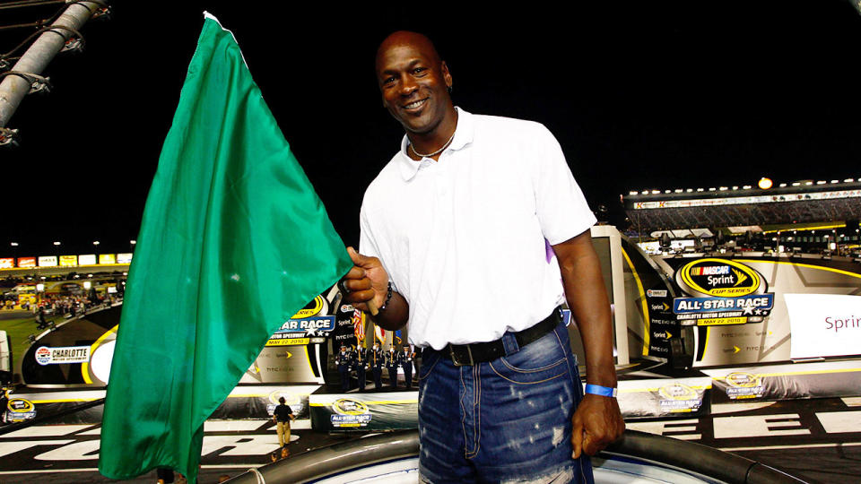 Pictured here, Michael Jordan waves a flag at a NASCAR race.