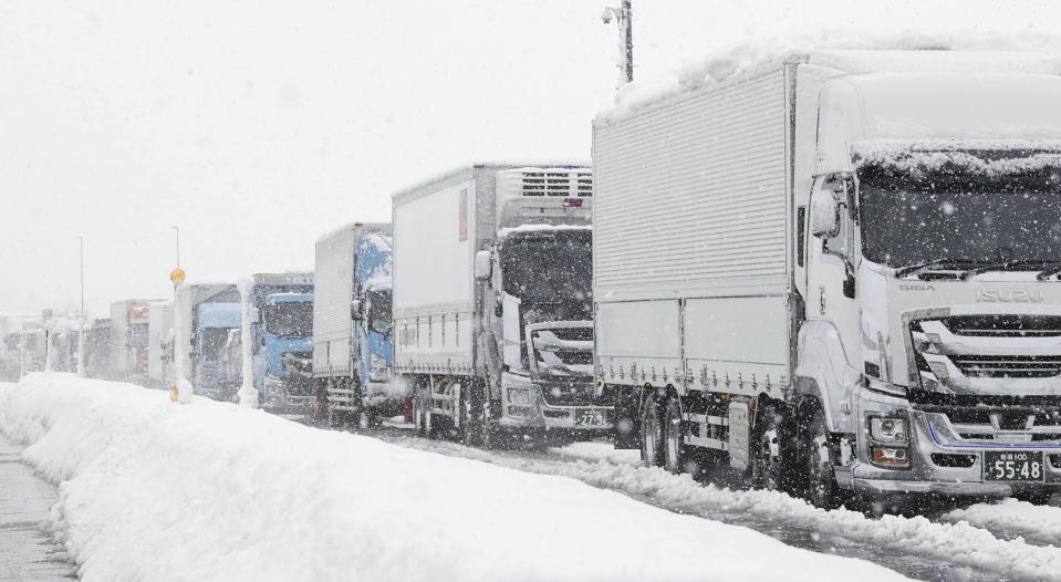 Cars get stuck on a road due to heavy snowfall Tuesdasy, Dec. 20, 2022 in Nagaoka, Niigata prefecture, northern Japan. (Miyuki Saito/Kyodo News via AP)