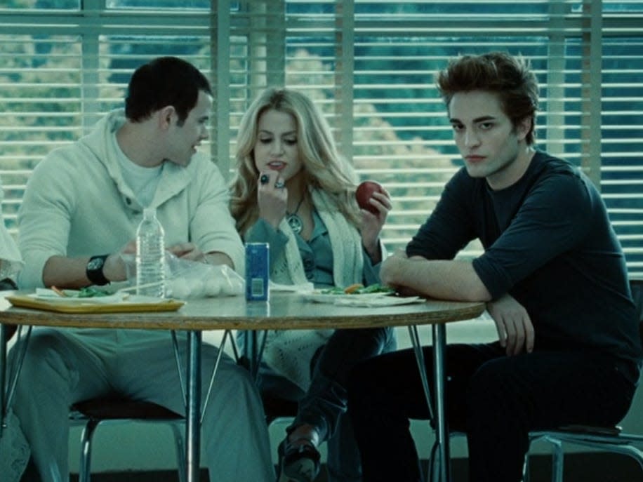 The cullens sitting at the table, all except edward dressed in white, in twilight