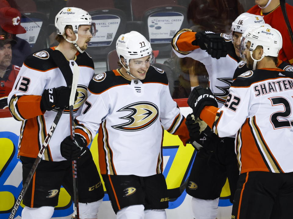 Anaheim Ducks forward Frank Vatrano, center, celebrates after his goal with teammates during first-period NHL hockey game action against the Calgary Flames in Calgary, Alberta, Sunday, April 2, 2023. (Jeff McIntosh/The Canadian Press via AP)