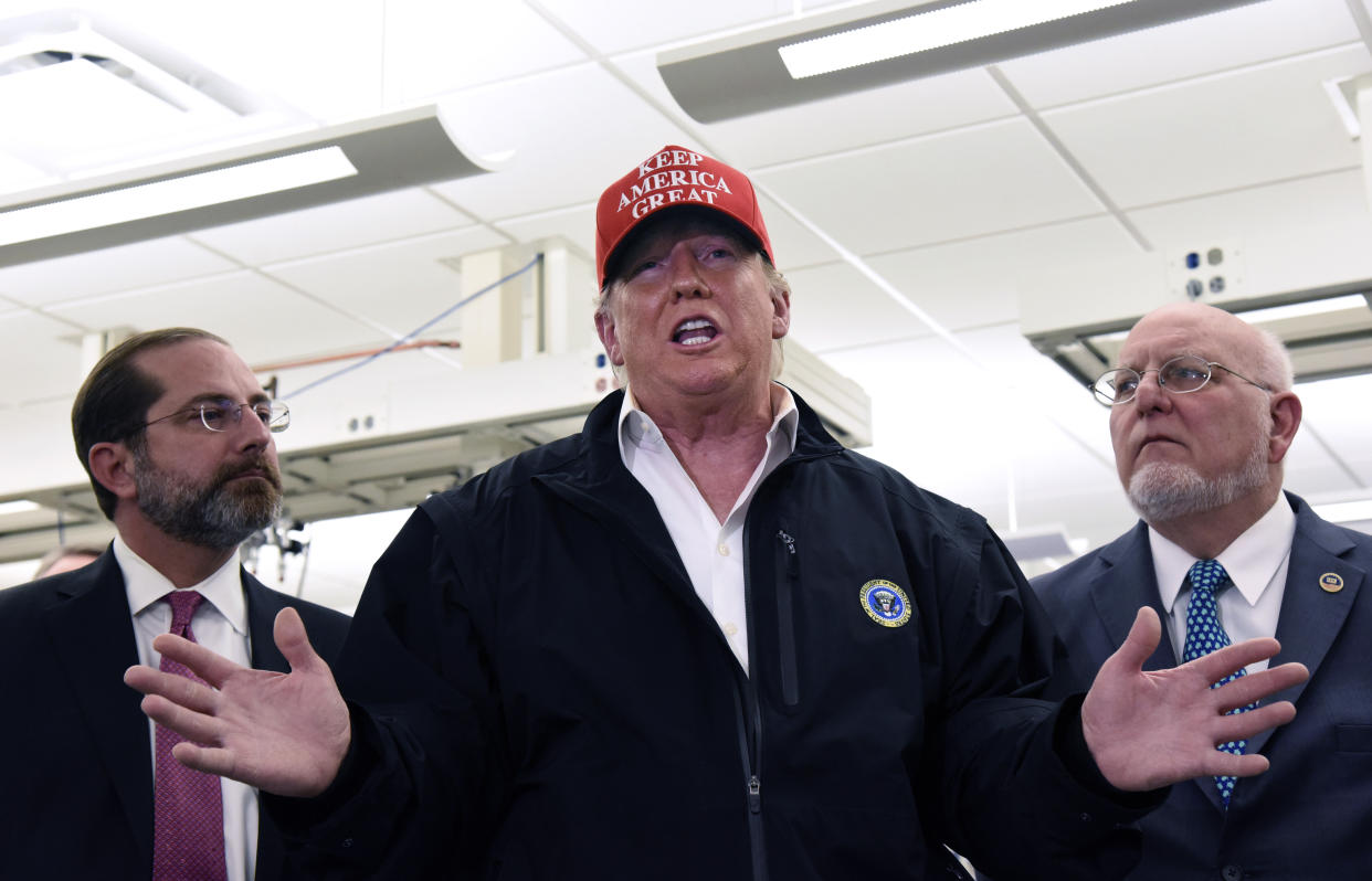 President Trump speaks as Health and Human Services Secretary Alex Azar (left) and Centers for Disease Control Director Robert Redfield (right) look on at the CDC headquarters in Atlanta on Friday. (Hyosub Shin/AJC)