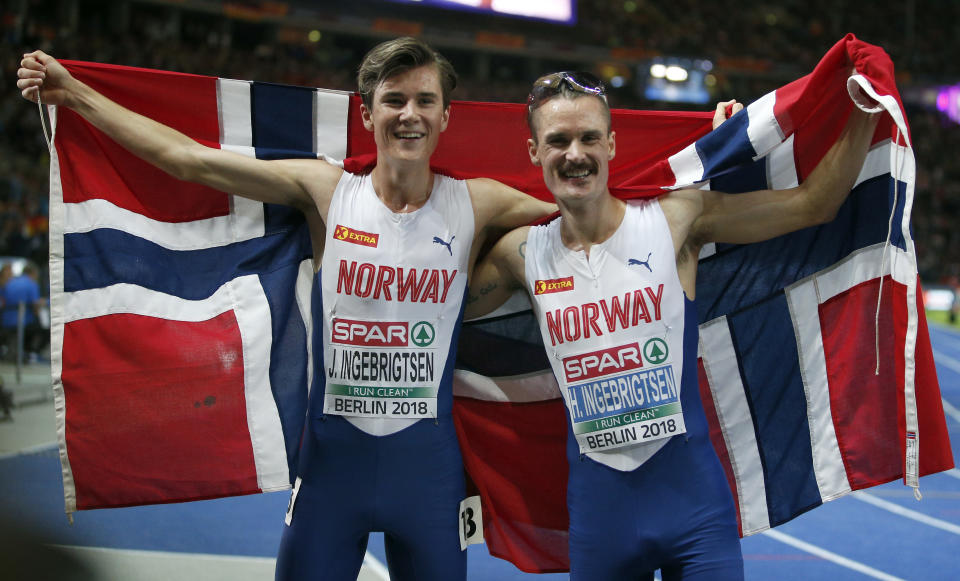 Norway's gold medalist Jakob Ingebrigtsen, left, and his brother and silver medal winner, Henrik Ingebrigtsen, right, celebrate after the men's 5.000 meter final race at the European Athletics Championships in Berlin, Germany, Saturday, Aug. 11, 2018. (AP Photo/Michael Sohn)