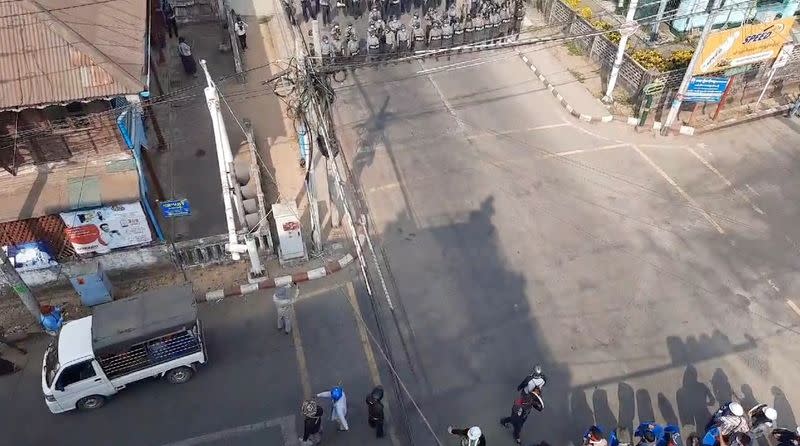 Police form up at a junction as protesters demonstrate against the military coup in Dawei, Myanmar, in this still frame obtained from social media video dated February 27, 2021