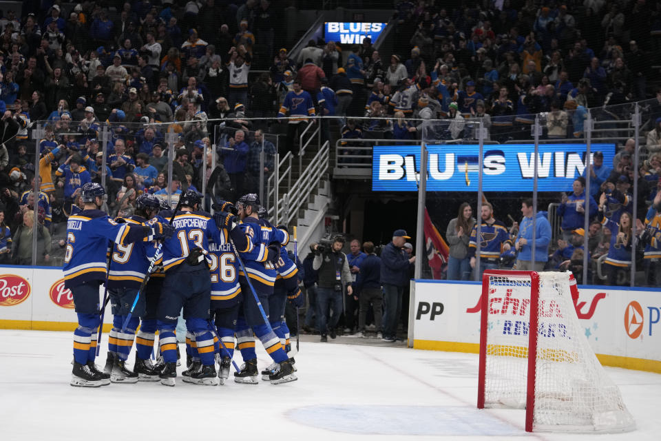 St. Louis Blues' Brayden Schenn (10) is congratulated by teammates after scoring the game-winning goal during overtime of an NHL hockey game against the Los Angeles Kings Sunday, Jan. 28, 2024, in St. Louis. (AP Photo/Jeff Roberson)