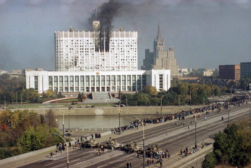 FILE - Smoke comes out of the Russian parliament building after a full scale assault by tanks and commandos loyal to President Boris Yeltsin, in Moscow on Oct. 4, 1993. Three decades ago, the world held its breath as tanks blasted the Russian parliament building in central Moscow while the Kremlin moved to flush out rebellious lawmakers in a crisis that shaped the country's post-Soviet history. (AP Photo/Sergei Karpukhin, File)