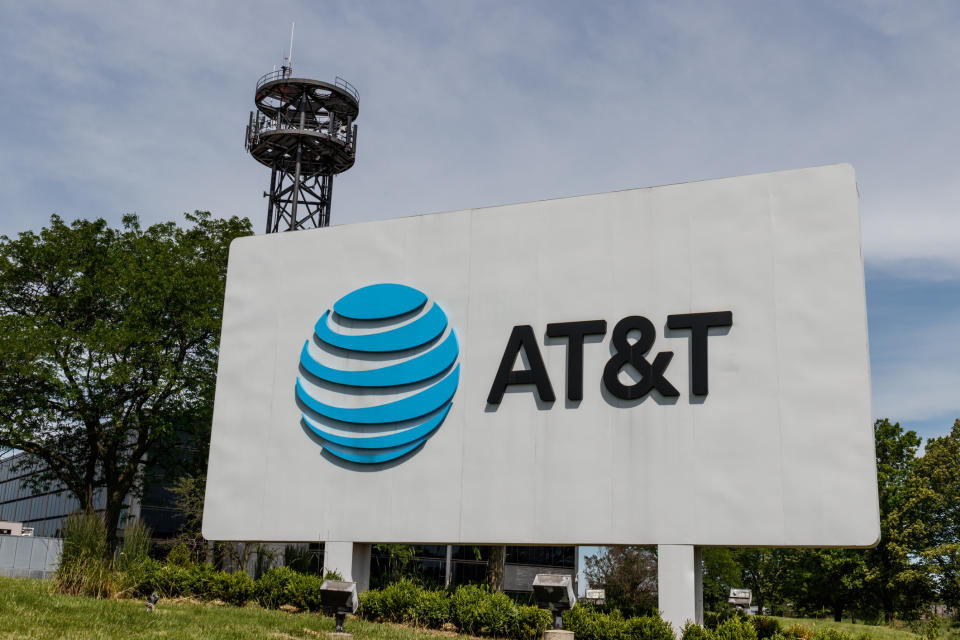 AT&T sign in front of a building with a tower in the background