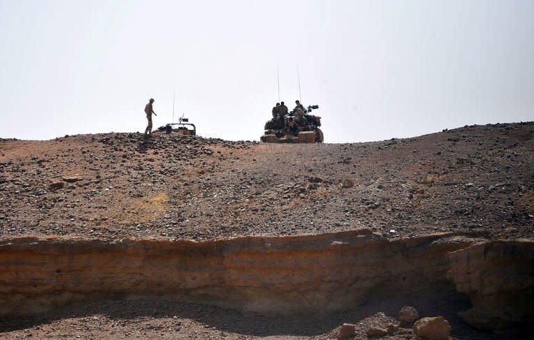 French soldiers stand guard near a bridge on the Niger River on February 3, 2013 in Gao. In all, the crisis has caused some 377,000 people to flee their homes, including 150,000 who have sought refuge across Mali's borders, according to the United Nations