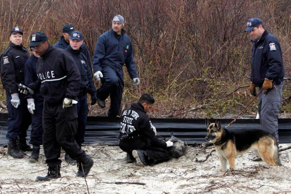 Investigators are seen searching the shores of Gilgo Beach in 2011 (AP2011)