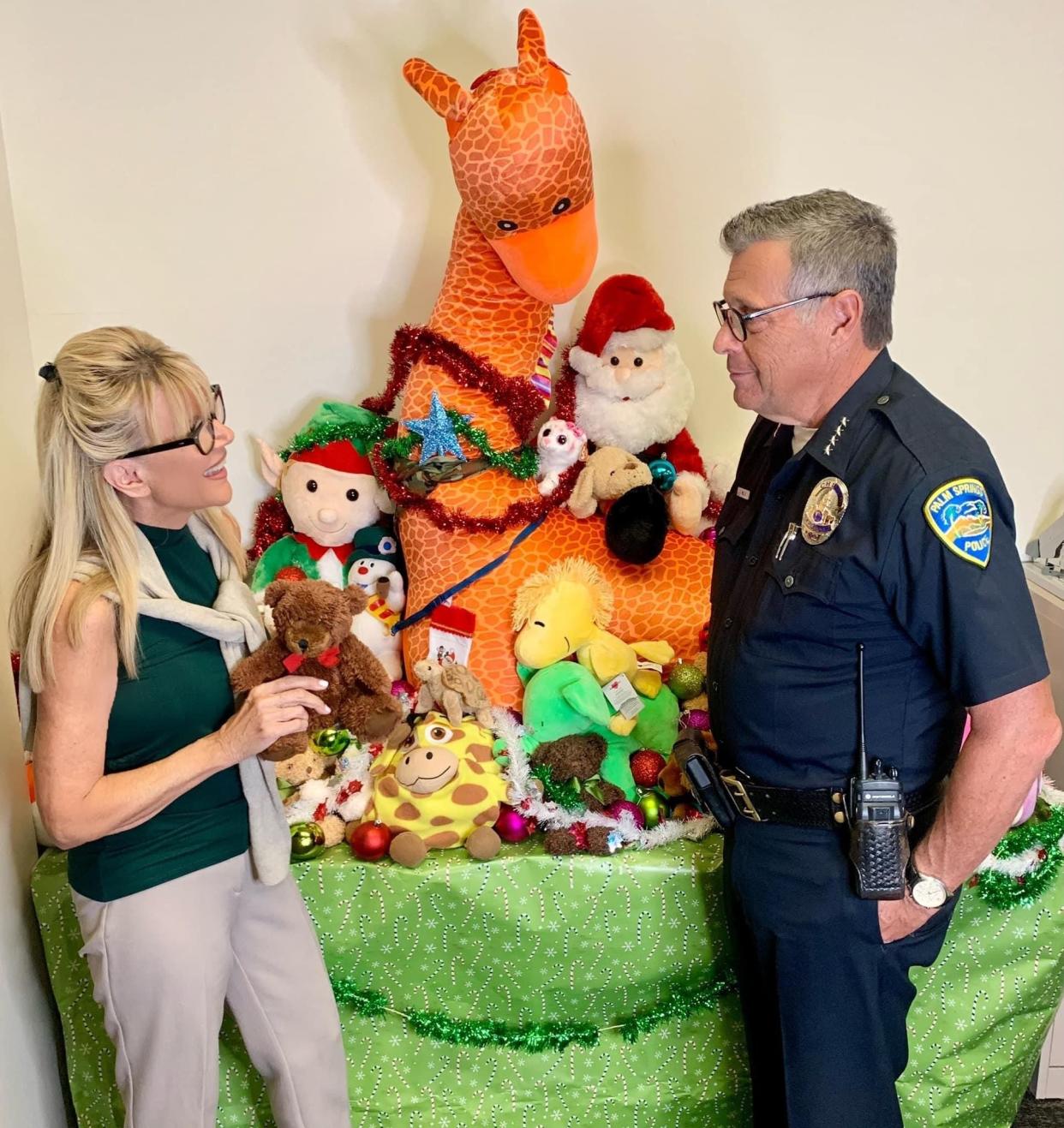 Sandie and Chief Andy Mills at the Palm Springs Police Department's  "Shop With a Cop" stuffed animal and toy display.