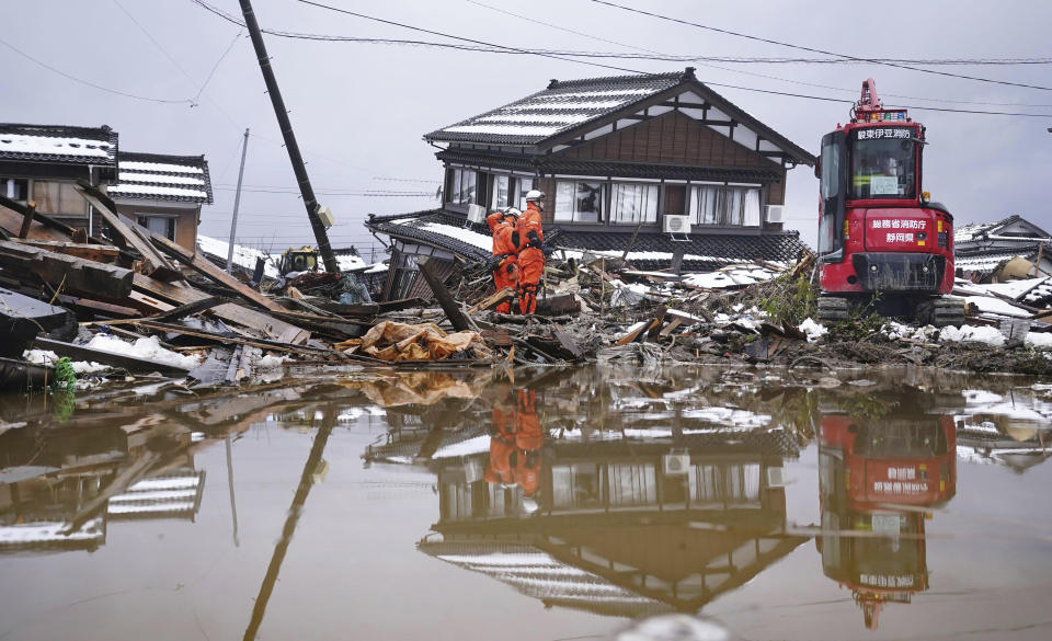 Firefighters conduct a search operation in Suzu, Ishikawa prefecture, Japan Tuesday, Jan. 9, 2024. Thousands of people made homeless by a powerful earthquake on the western coast of Japan were coping with weariness and uncertainty a week after the temblor. (Kyodo News via AP)