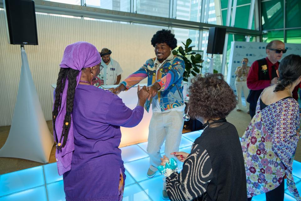 Los Angeles Chargers safety Derwin James dances with a woman at the dance party he hosted at GenSpace, a community center for the older population of Los Angeles.