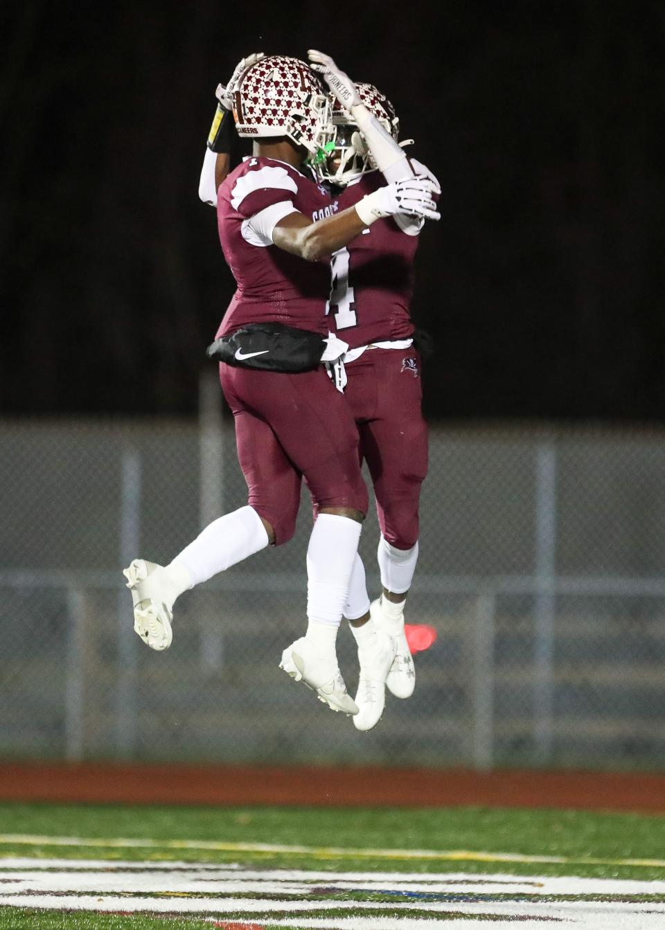 Caravel senior Vandrick Hamlin III and sophomore Charles Broadard celebrate a touchdown in the Buccaneers’ 36-0 win over the Wildcats, Friday, Nov. 24, 2023 in a Class 2A DIAA football semifinal at Bob Peoples Stadium.