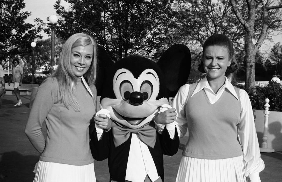 Mickey Mouse posing with Disney World's early cast members.