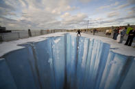 The 3D street painting "Crevasse" by artist Edgar Mueller is seen in this undated picture during the "Festival of culture" from August 21-24, 2008 in Dun Laoghaire, Irland. Edgar Mueller put a part of the eastern Pier into the ice age. This project has been supported by the Goethe Institution Germany. (Photo by Edgar Mueller/Getty Images)