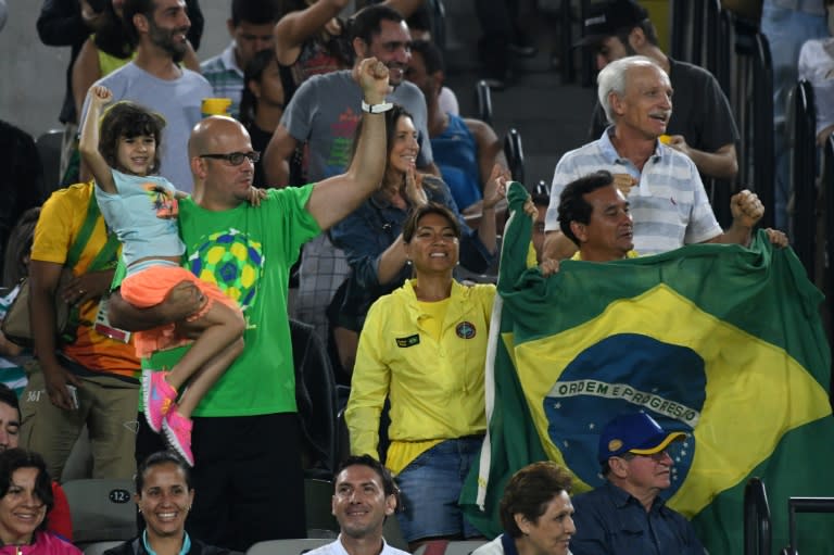 Brazil fans cheer as Brazil's Thomaz Belluci scores a point against Uruguay's Pablo Cuevas in Rio on August 9, 2016