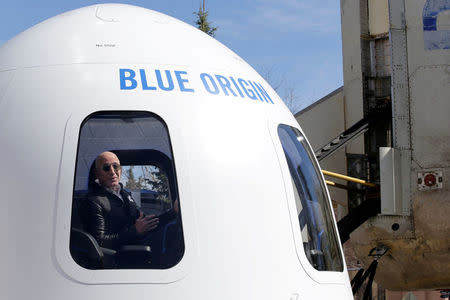 FILE PHOTO: Amazon and Blue Origin founder Jeff Bezos addresses the media about the New Shepard rocket booster and Crew Capsule mockup at the 33rd Space Symposium in Colorado Springs, Colorado, United States April 5, 2017. REUTERS/Isaiah J. Downing/File Photo