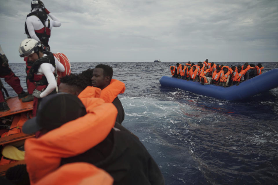 Migrants on a blue rubber boat wait to be rescued some 14 nautical miles from the coast of Libya in Mediterranean Sea, Sunday, Sept. 8, 2019. Humanitarian groups SOS Mediterranee and Doctors Without Borders have successfully rescued 50 migrants and brought them aboard the Ocean Viking. (AP Photo/Renata Brito)