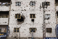 <p>Sana’a building facade,Sana’a, Yemen April 29, 2017: A building damaged by ground fighting and gunfire during conflict in 2011. (Photograph by Giles Clarke for UN OCHA/Getty Images) </p>