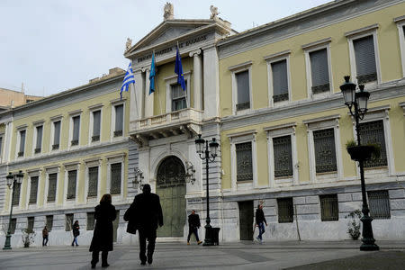 People make their way past the National Bank of Greece headquarters in central Athens, Greece, February 19, 2017. REUTERS/Michalis Karagiannis