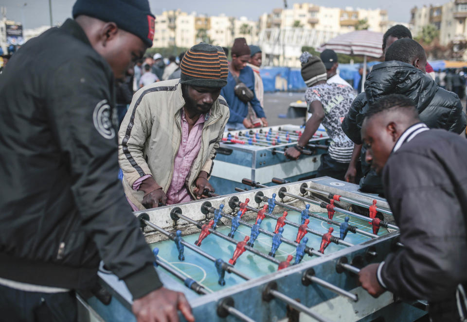 Sub-Saharan migrants compete at table football as a way to make money, at Ouled Ziane camp in Casablanca, Morocco, Thursday, Dec. 6, 2018. As Morocco prepares to host the signing of a landmark global migration agreement next week, hundreds of migrants are languishing in a Casablanca camp rife with hunger, misery and unsanitary conditions. These sub-Saharan Africans who dream of going to Europe are a symbol of the problems world dignitaries are trying to address with the U.N.'s first migration compact. (AP Photo/Mosa'ab Elshamy)