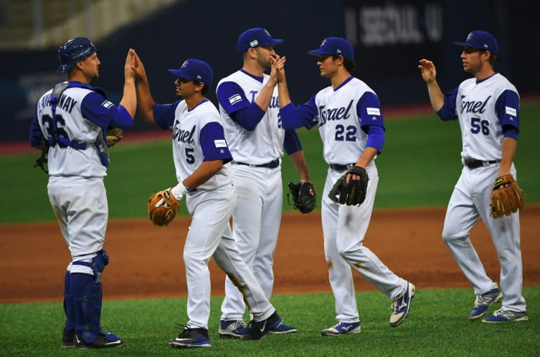 Israel's baseball team celebrate their victory against the Netherlands after their first round game of the World Baseball Classic at Gocheok Sky Dome in Seoul on March 9, 2017