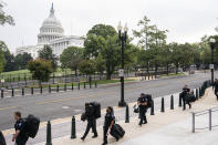 Police stage at a security fence ahead of a rally near the U.S. Capitol in Washington, Saturday, Sept. 18, 2021. The rally was planned by allies of former President Donald Trump and aimed at supporting the so-called "political prisoners" of the Jan. 6 insurrection at the U.S. Capitol. (AP Photo/Nathan Howard)